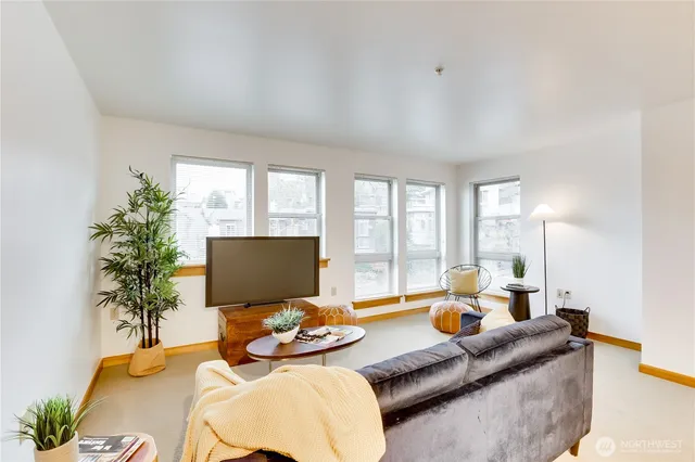 a living room with furniture and floor to ceiling window
