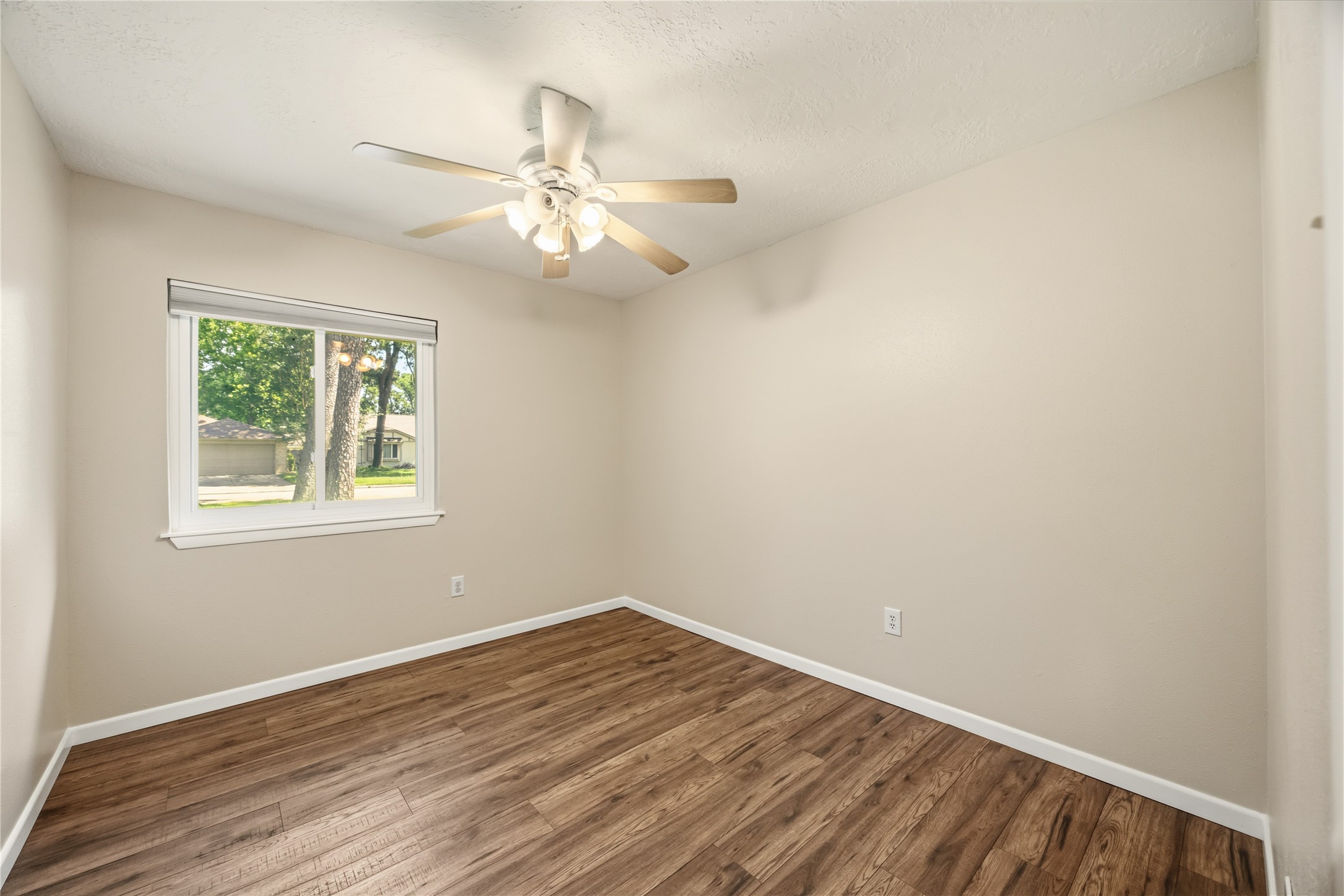 9635 Birsay Street Spring, TX 77379 - Photo 15 of 24 wooden floor in an empty room with a window