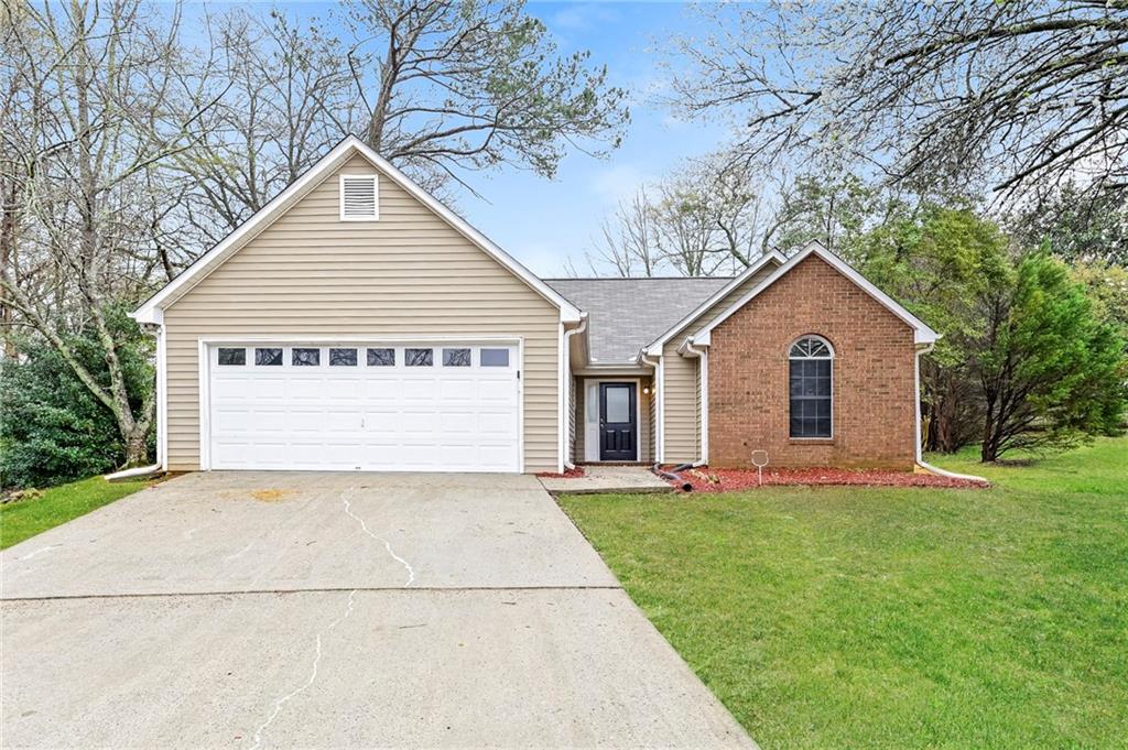 5986 Creekside Drive Rex, GA 30273 - Photo 1 of 1 a front view of a house with a yard and garage