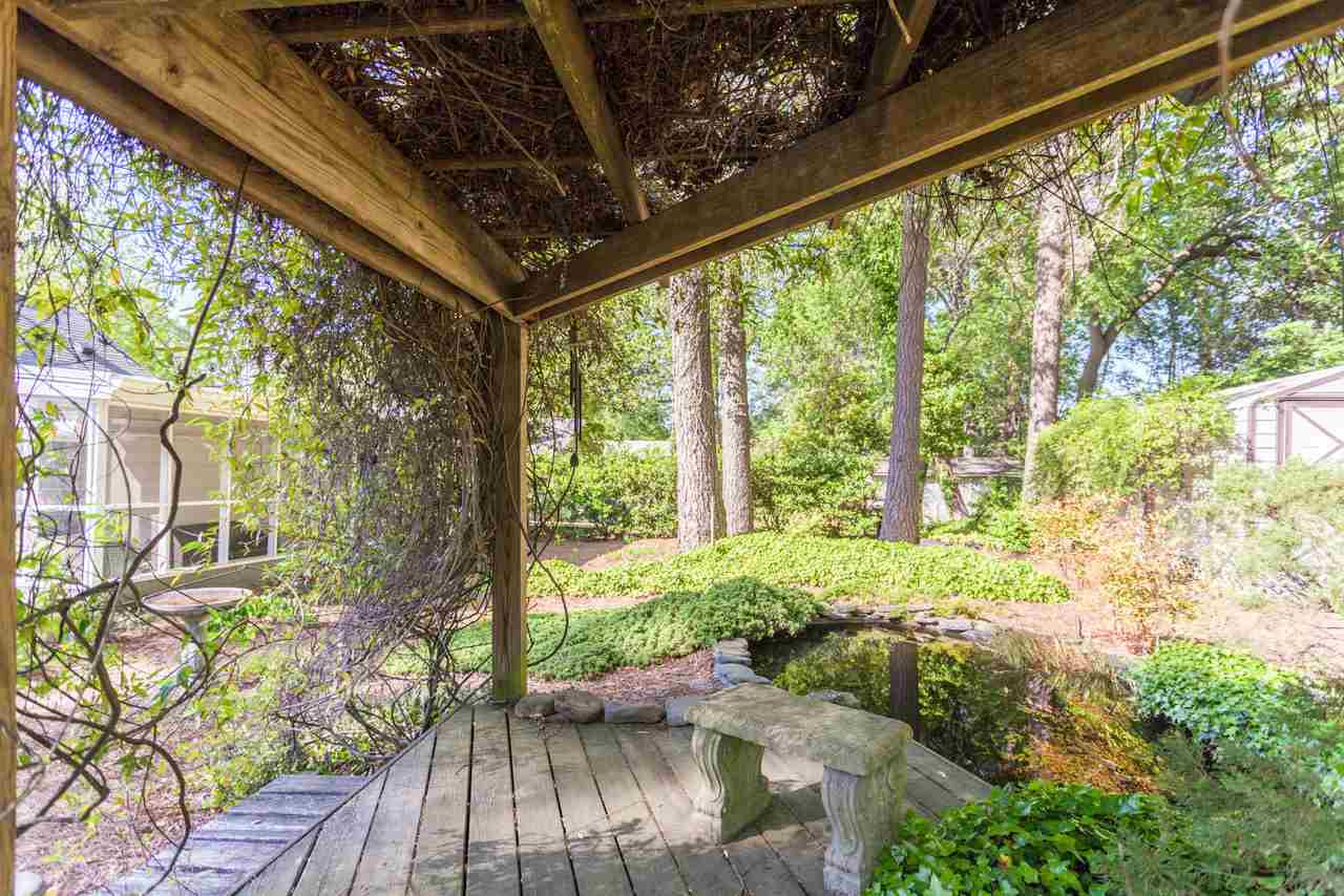 1306 Courtland Drive Raleigh, NC 27604 - Photo 20 of 22 One view from the pergola-covered deck by the pond.