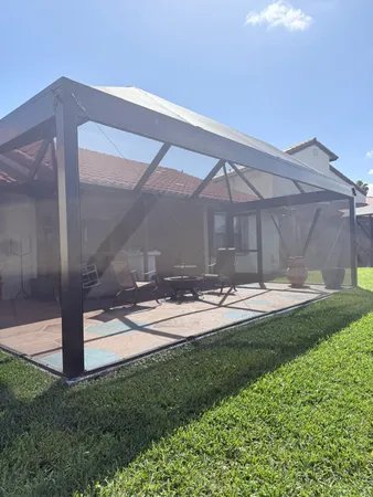 a front view of a house with a yard and a garden