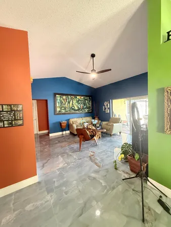 a view of a livingroom with furniture and a window