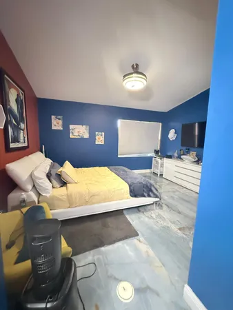 a bedroom with a bed and ceiling fan