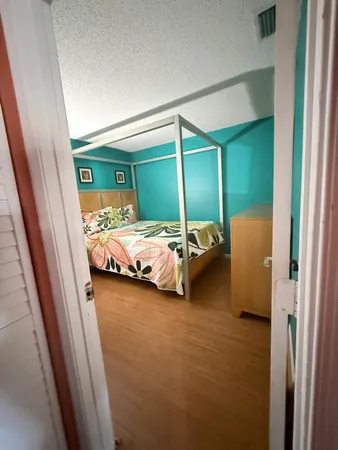 a bedroom with a bed and a mirror