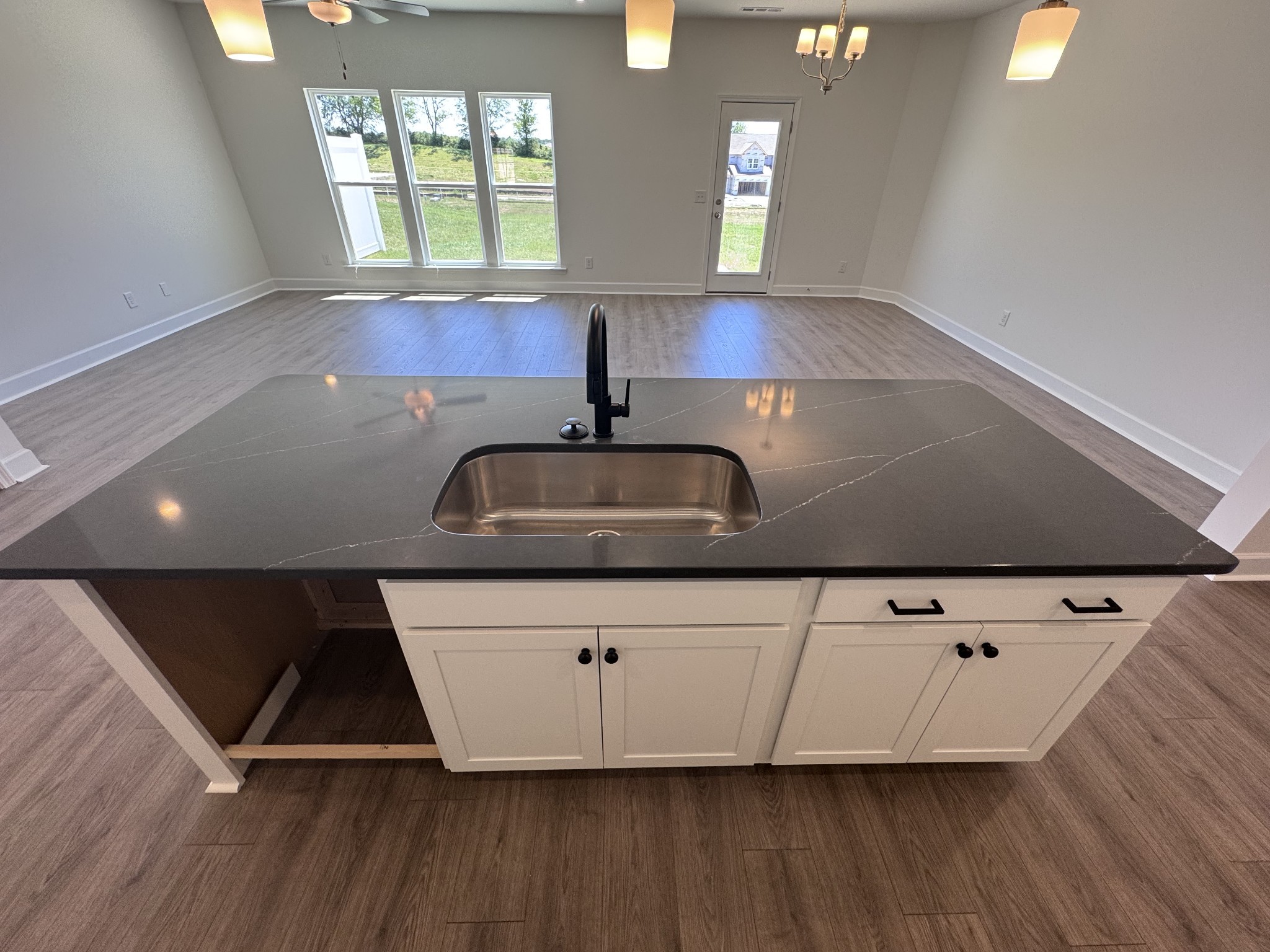 1095 June Wilde Ridge Spring Hill, TN 37174 - Photo 12 of 33 a kitchen with kitchen island granite countertop a sink and a stove