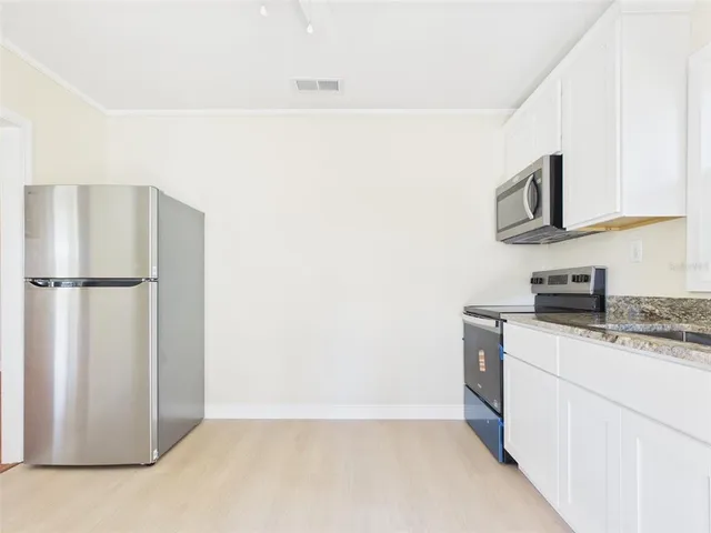 a kitchen with stainless steel appliances a refrigerator and a stove