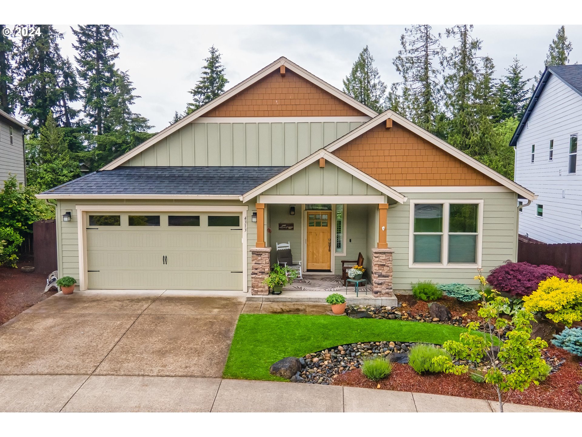 4313 North Ridgefield Woods Drive Ridgefield, WA 98642 - Photo 1 of 24 a front view of a house with sitting area and garden