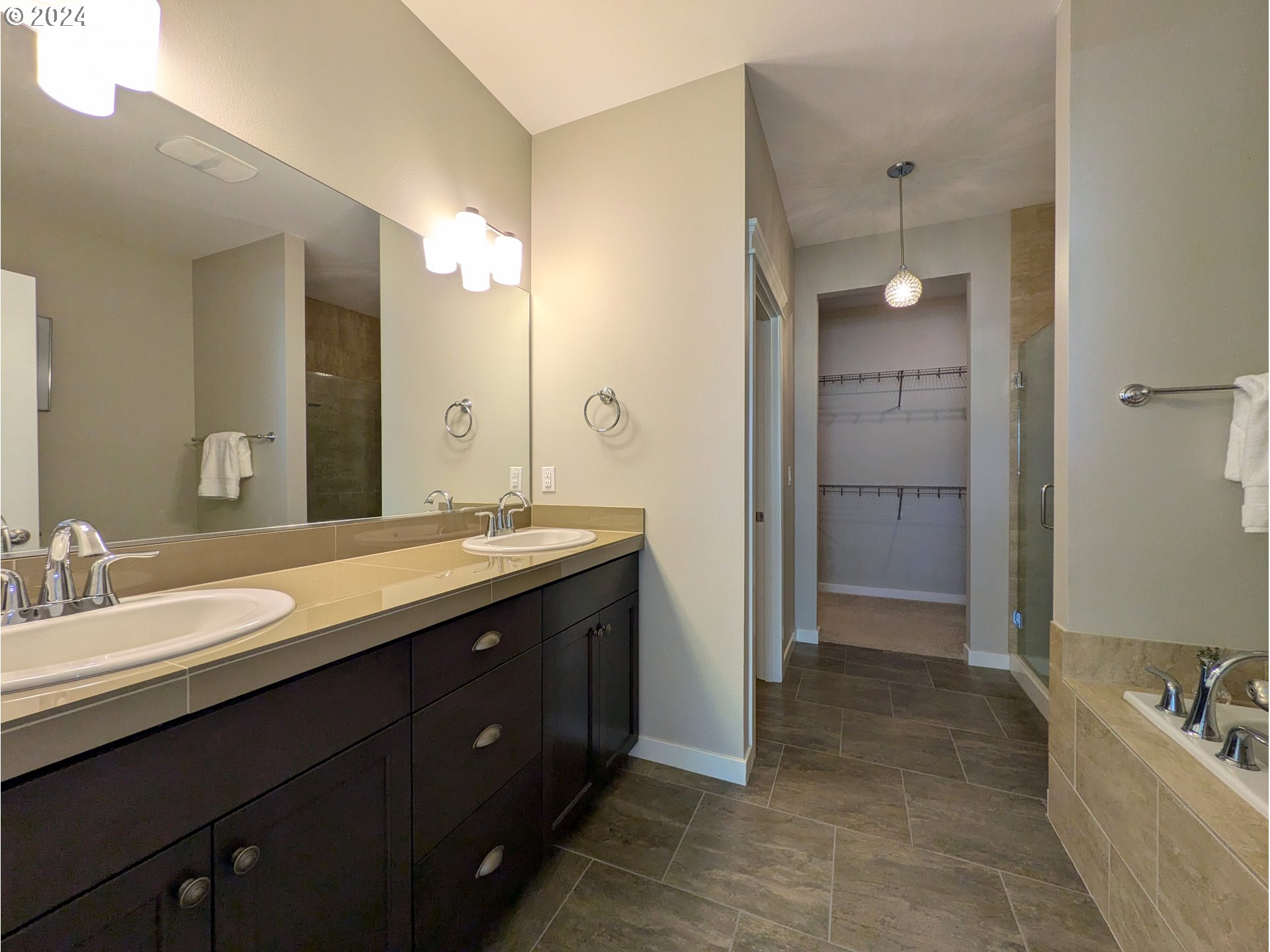 4313 North Ridgefield Woods Drive Ridgefield, WA 98642 - Photo 16 of 24 a spacious bathroom with a double vanity sink a large mirror and a shower