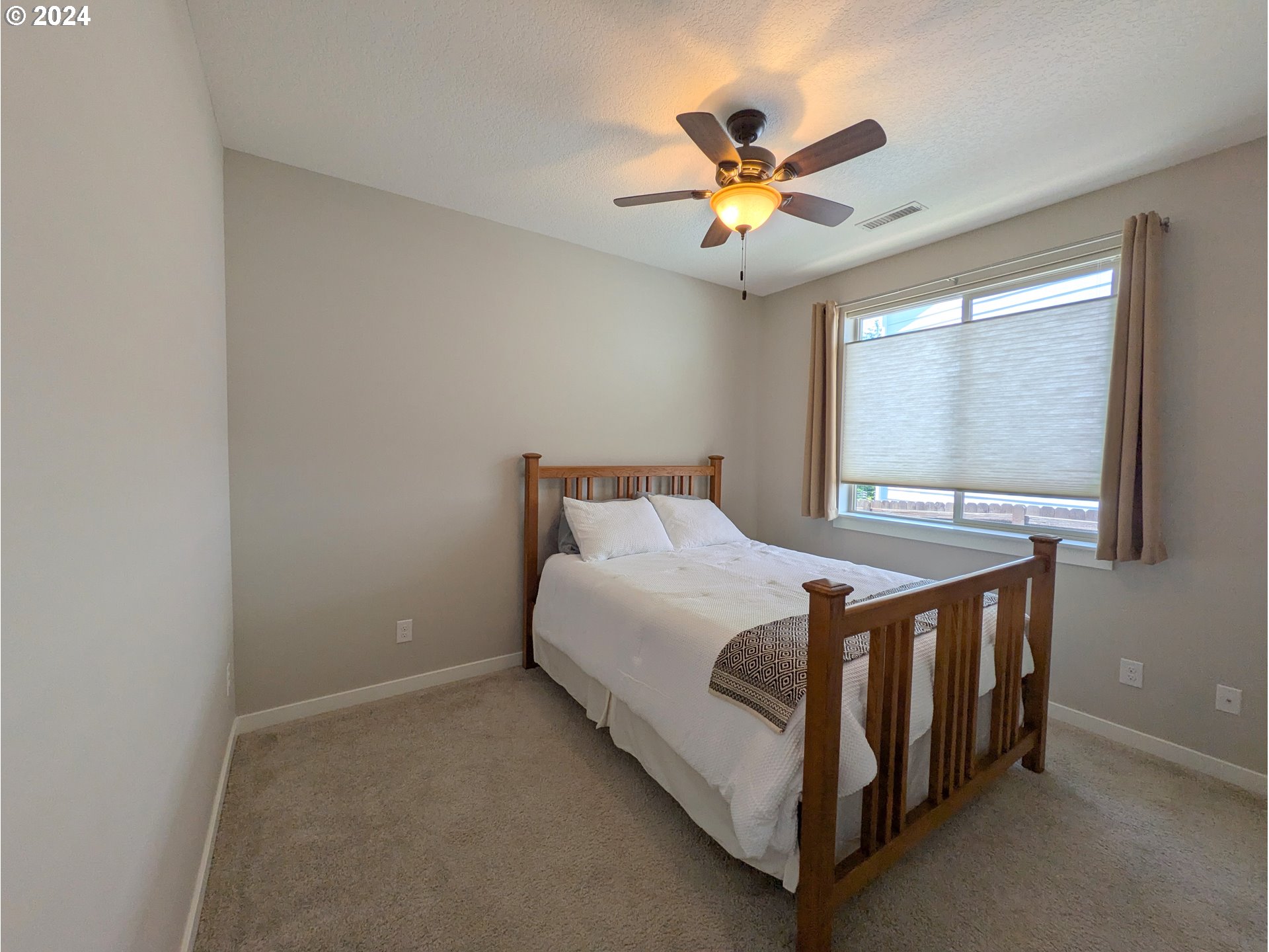 4313 North Ridgefield Woods Drive Ridgefield, WA 98642 - Photo 19 of 24 a bed sitting in a bedroom next to a window