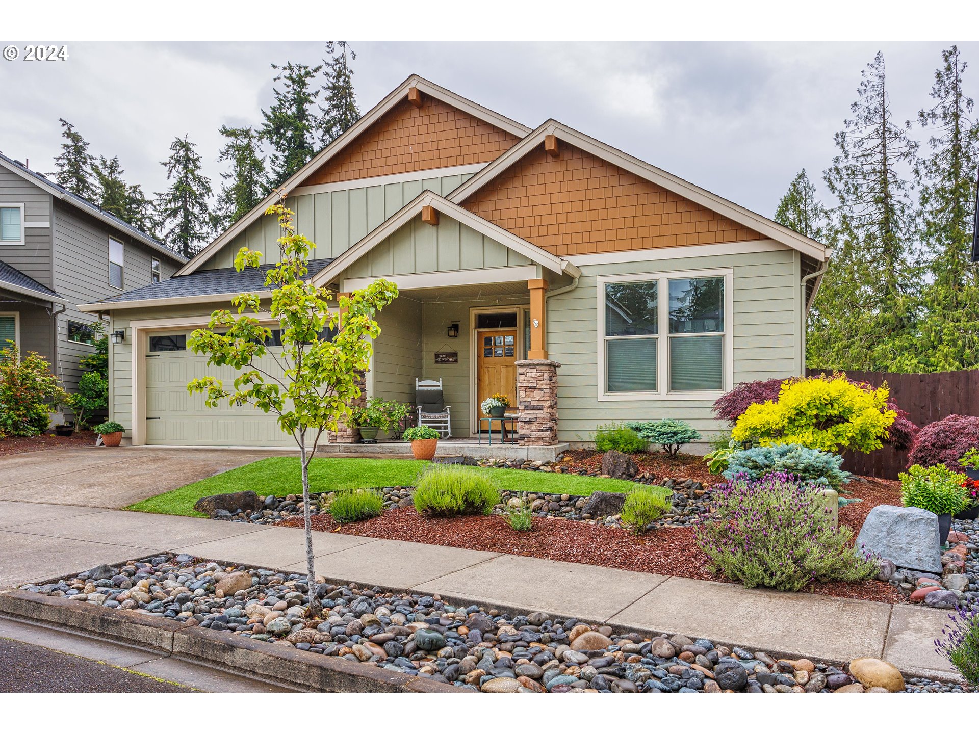 4313 North Ridgefield Woods Drive Ridgefield, WA 98642 - Photo 3 of 24 a front view of a house with a yard and potted plants