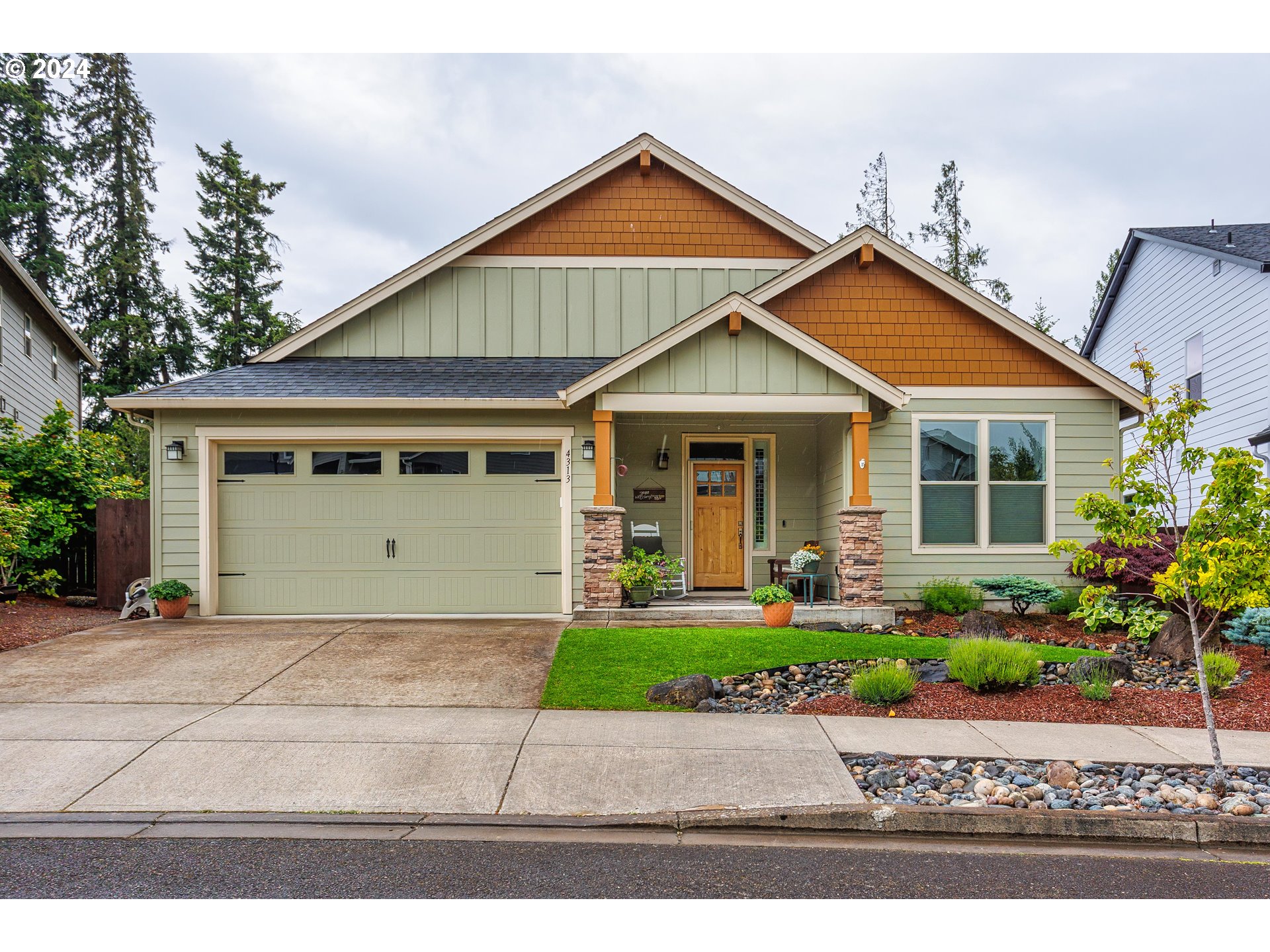 4313 North Ridgefield Woods Drive Ridgefield, WA 98642 - Photo 4 of 24 a front view of a house with a yard and potted plants