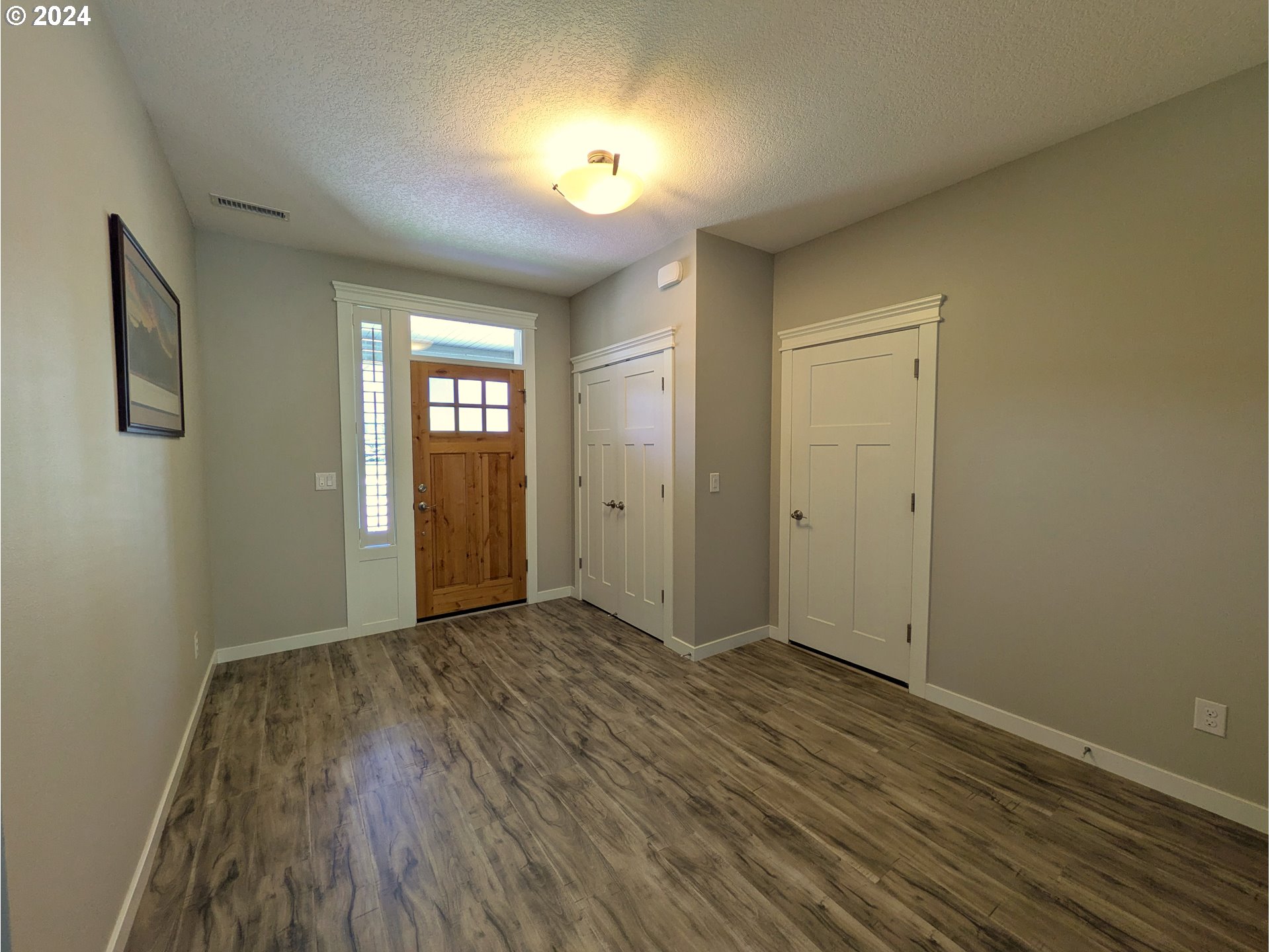4313 North Ridgefield Woods Drive Ridgefield, WA 98642 - Photo 7 of 24 a view of an empty room with window and wooden floor