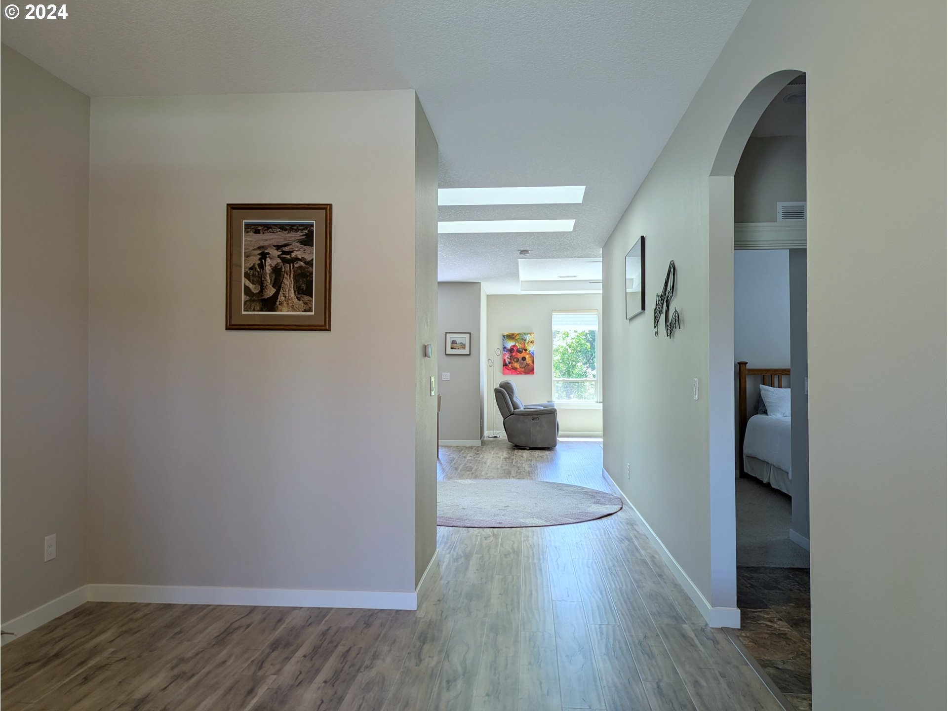 4313 North Ridgefield Woods Drive Ridgefield, WA 98642 - Photo 8 of 24 a view of a hallway with wooden floor and a living room