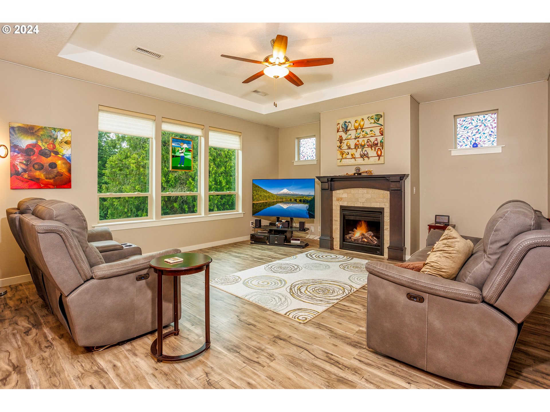 4313 North Ridgefield Woods Drive Ridgefield, WA 98642 - Photo 9 of 24 a living room with furniture a fireplace and a large window