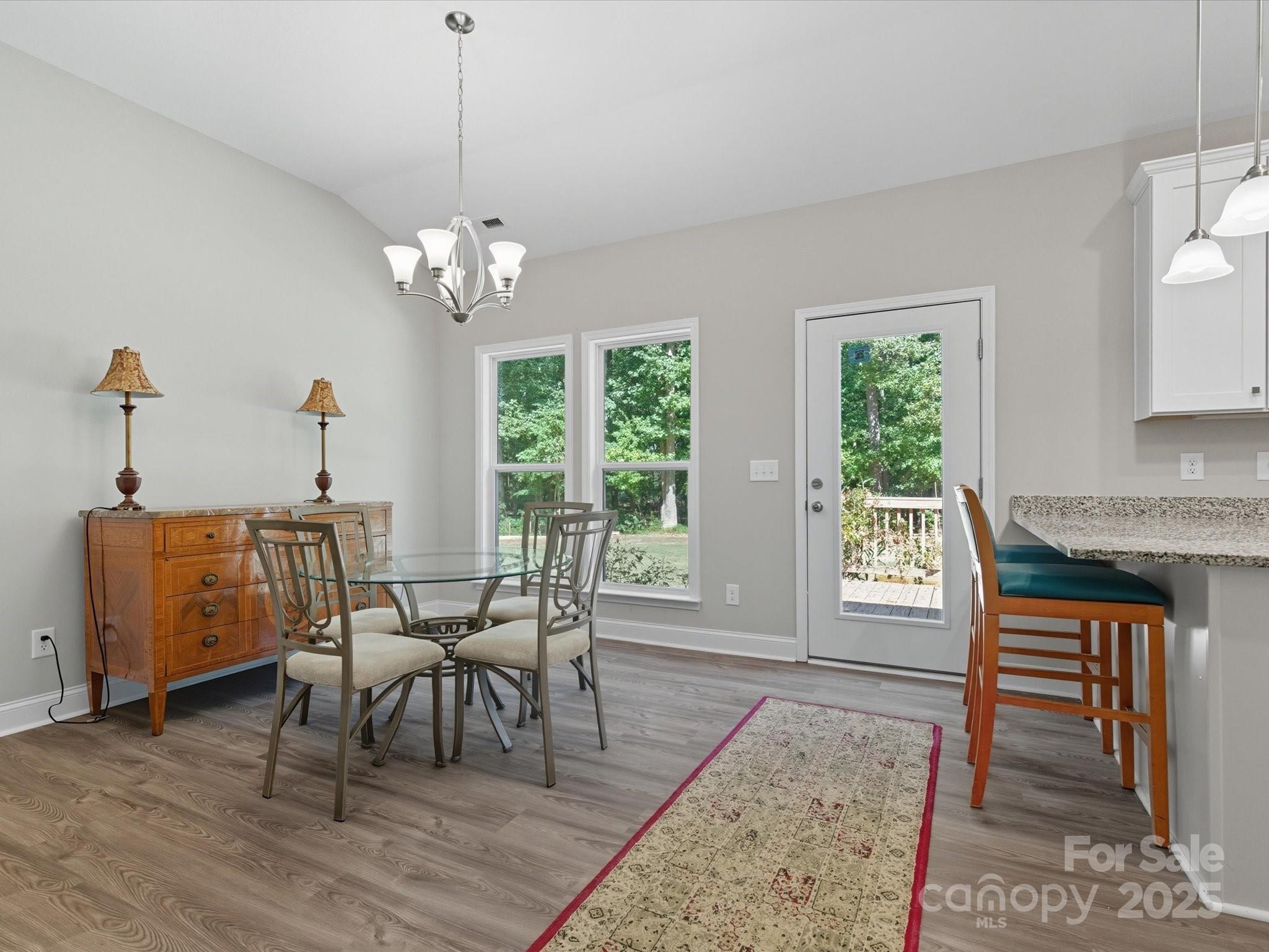 1830 Austin Chaney Road Wingate, NC 28174 - Photo 14 of 39 a dining room with furniture a chandelier and wooden floor