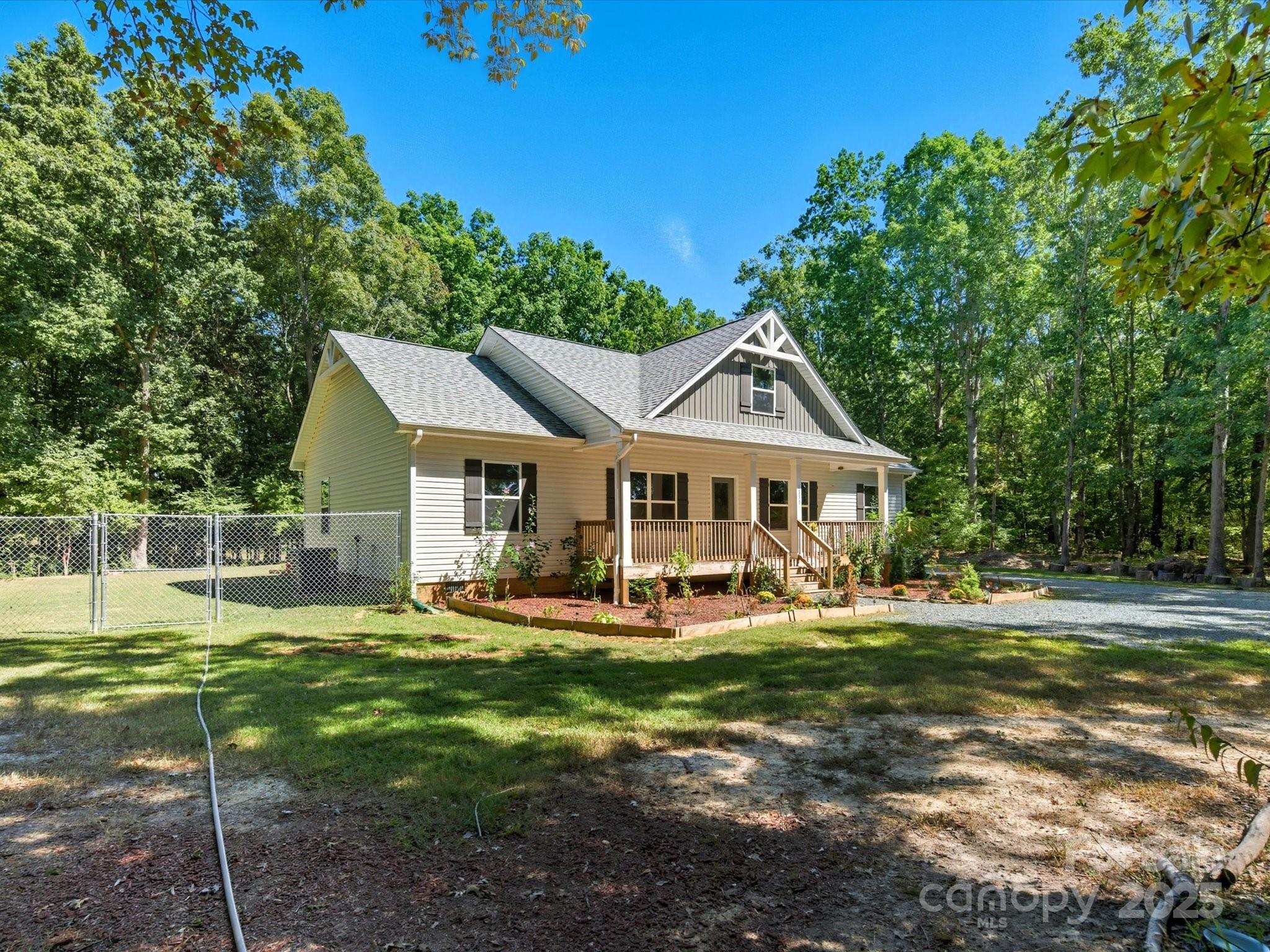 1830 Austin Chaney Road Wingate, NC 28174 - Photo 31 of 39 a front view of a house with a yard table and chairs