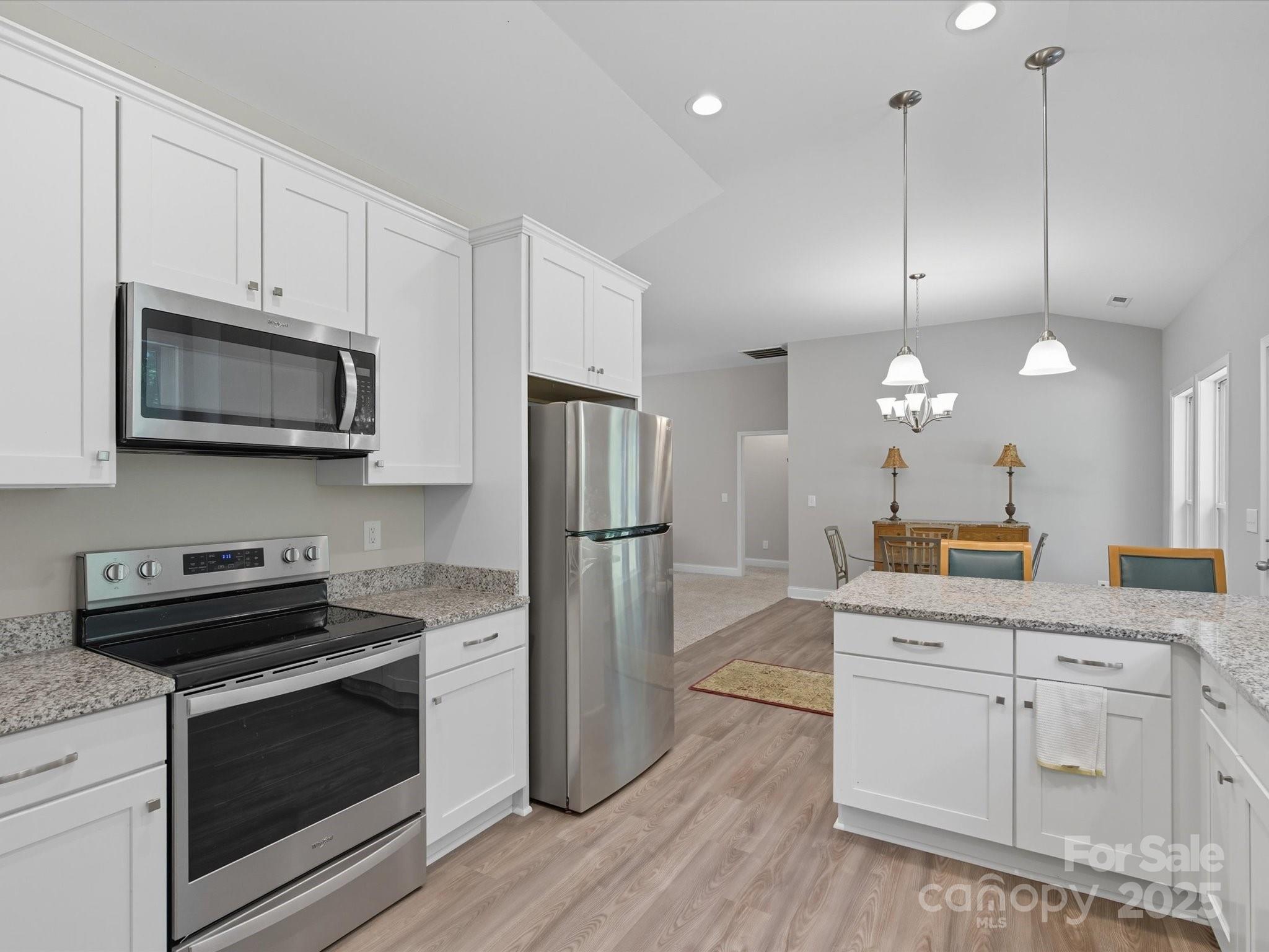 1830 Austin Chaney Road Wingate, NC 28174 - Photo 7 of 39 a kitchen with white cabinets and stainless steel appliances