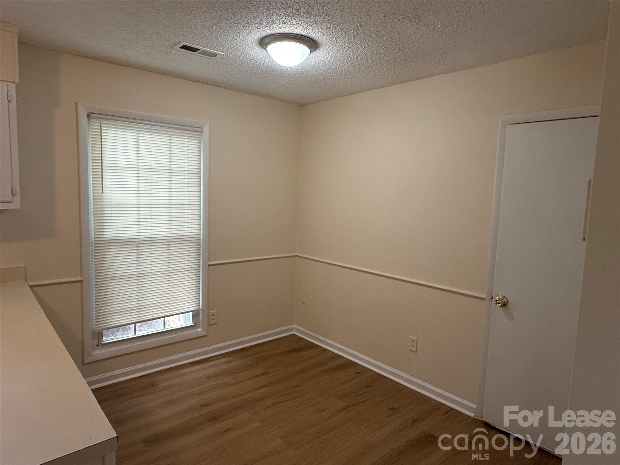 6341 Round Hill Road Charlotte, NC 28211 - Photo 5 of 16 a view of a room with wooden floor and windows