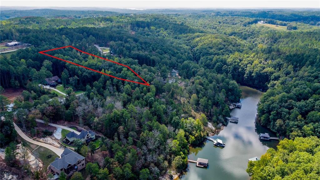 Lot 30 Harbor Point Seneca, SC 29672 - Photo 12 of 12 A prime waterfront parcel awaits, nestled within a lush, treed landscape offering serene water views.