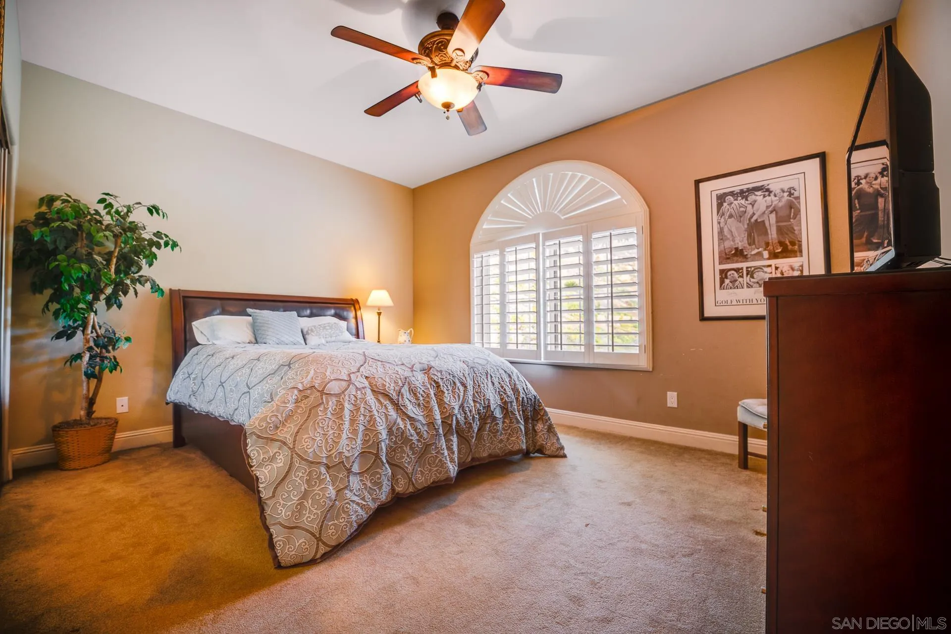 15380 Oak Canyon Road Poway, CA 92064 - Photo 21 of 52 a spacious bedroom with a bed and a chandelier
