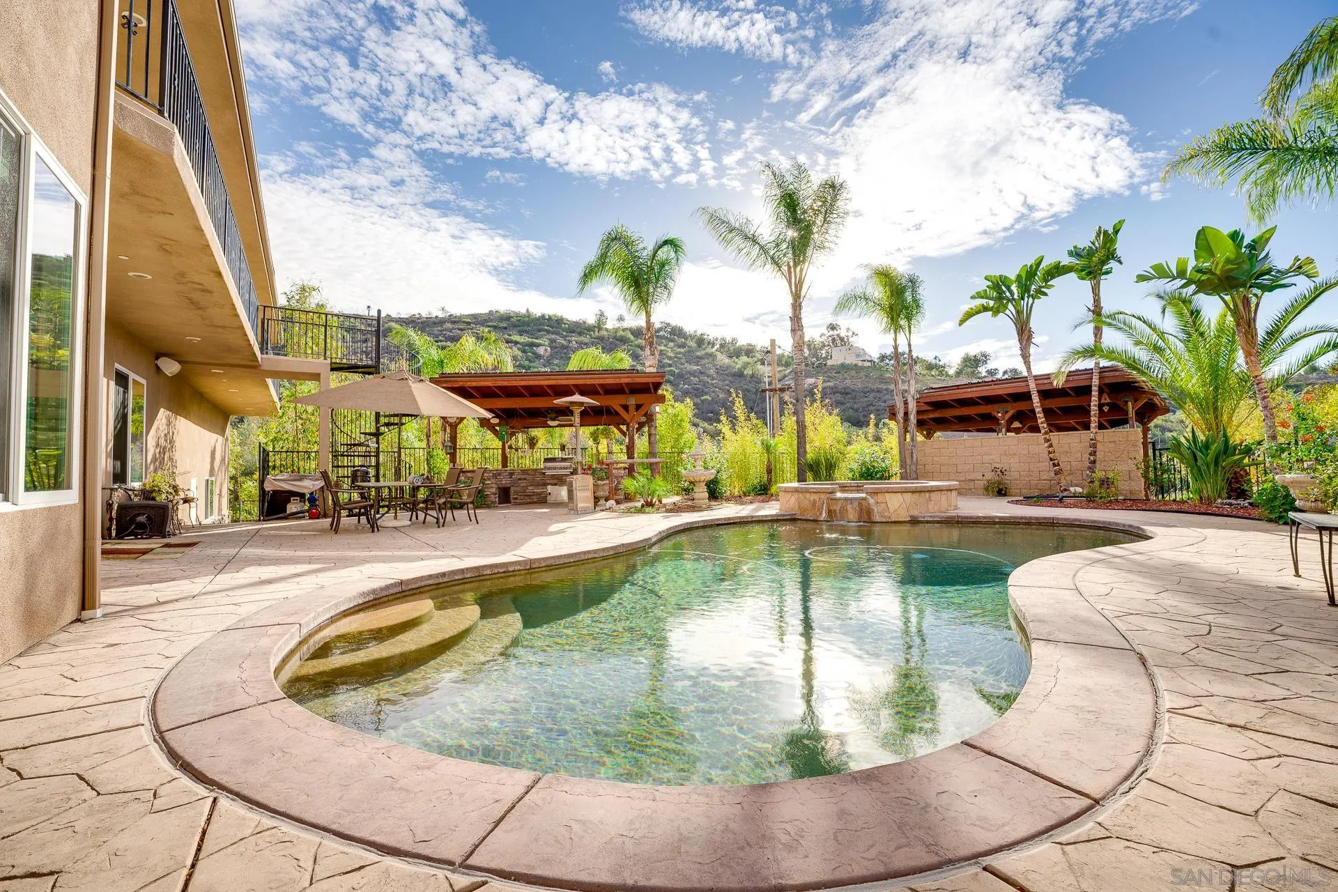15380 Oak Canyon Road Poway, CA 92064 - Photo 30 of 52 a view of a swimming pool with a patio