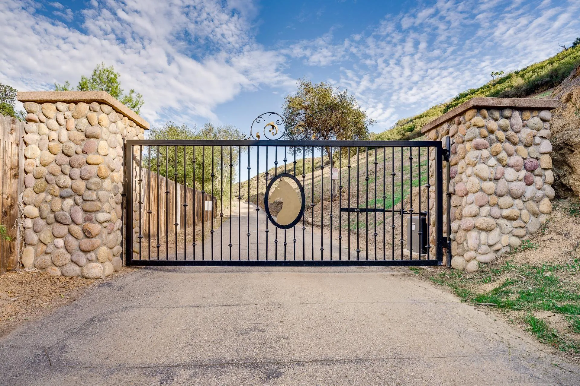 15380 Oak Canyon Road Poway, CA 92064 - Photo 3 of 52 a view of a gate with wooden fence