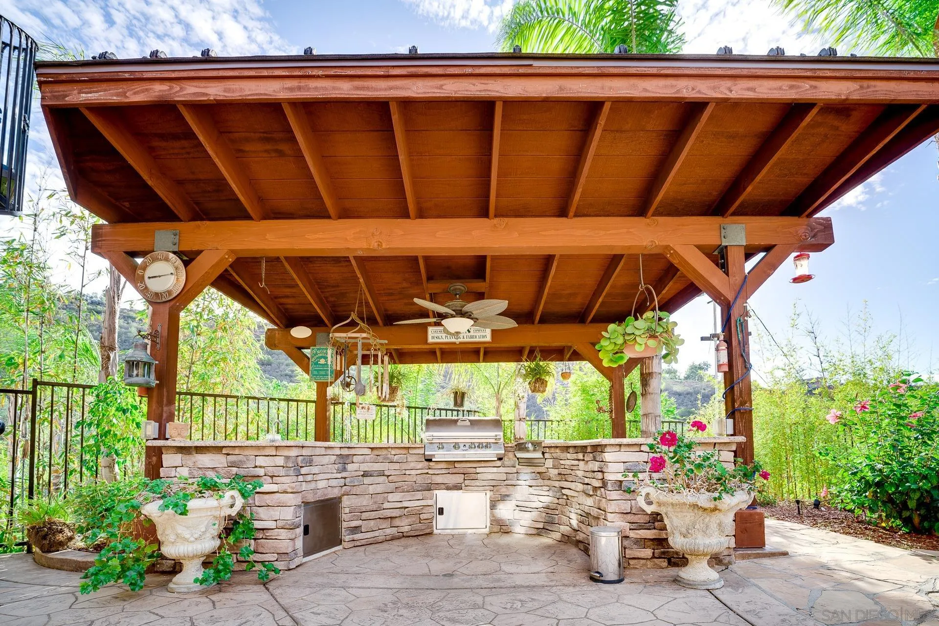 15380 Oak Canyon Road Poway, CA 92064 - Photo 33 of 52 a view of patio with a table and chairs under an umbrella with a potted plant