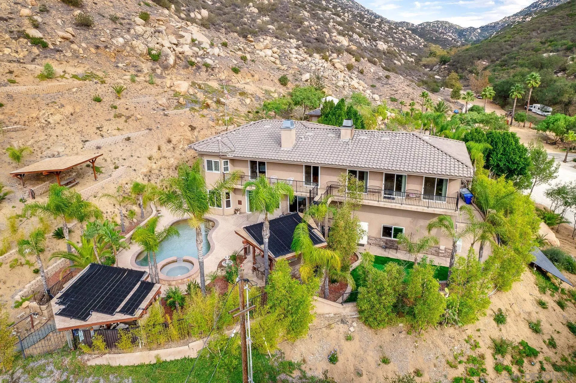 15380 Oak Canyon Road Poway, CA 92064 - Photo 42 of 52 a aerial view of a house with swimming pool garden and patio