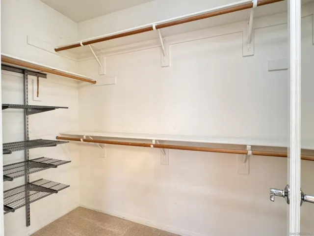 a view of a hallway with entryway and stairs