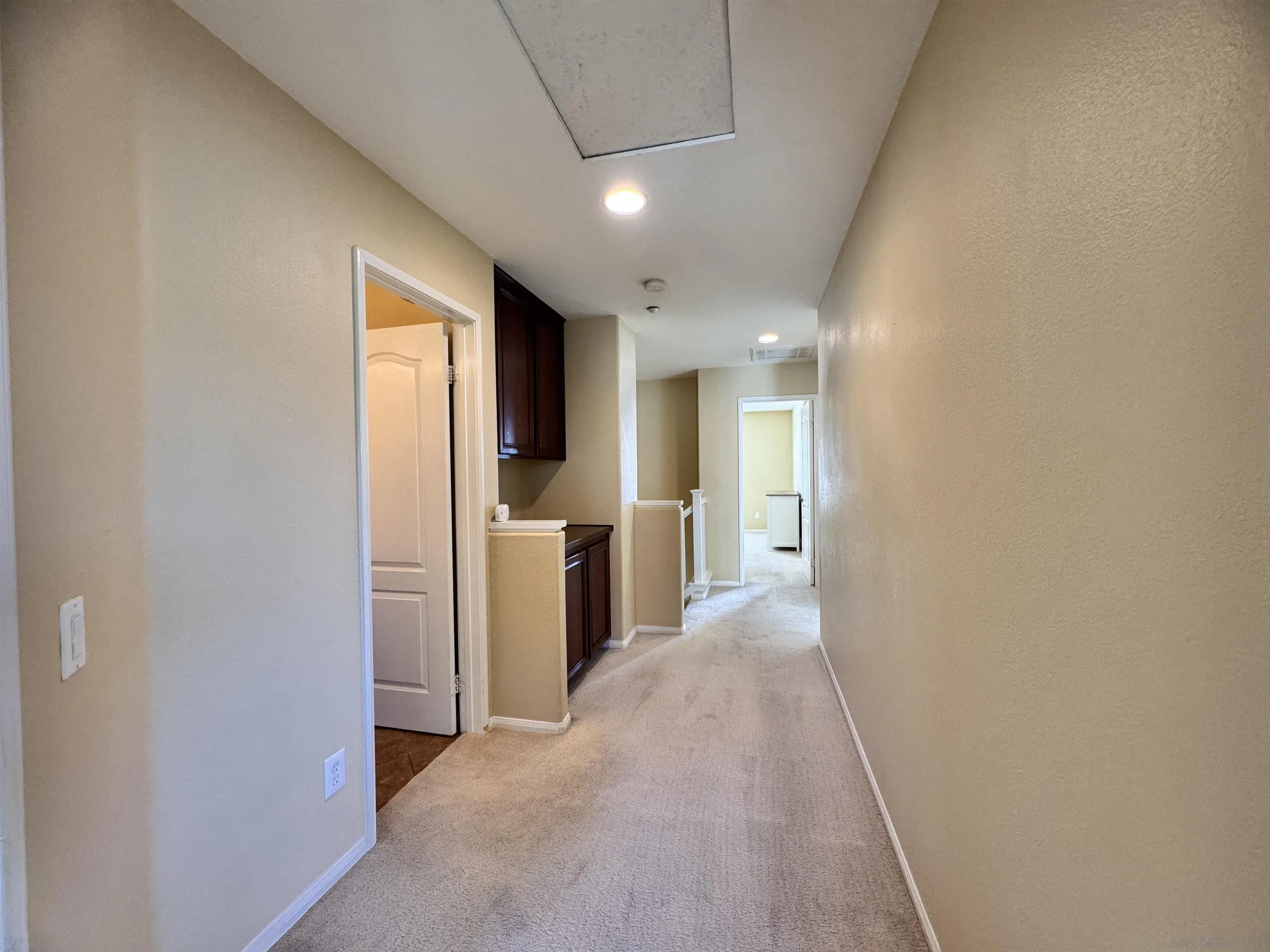 10430 Shelborne Street, Unit 37 San Diego, CA 92127 - Photo 19 of 27 a view of a hallway with wooden shelves