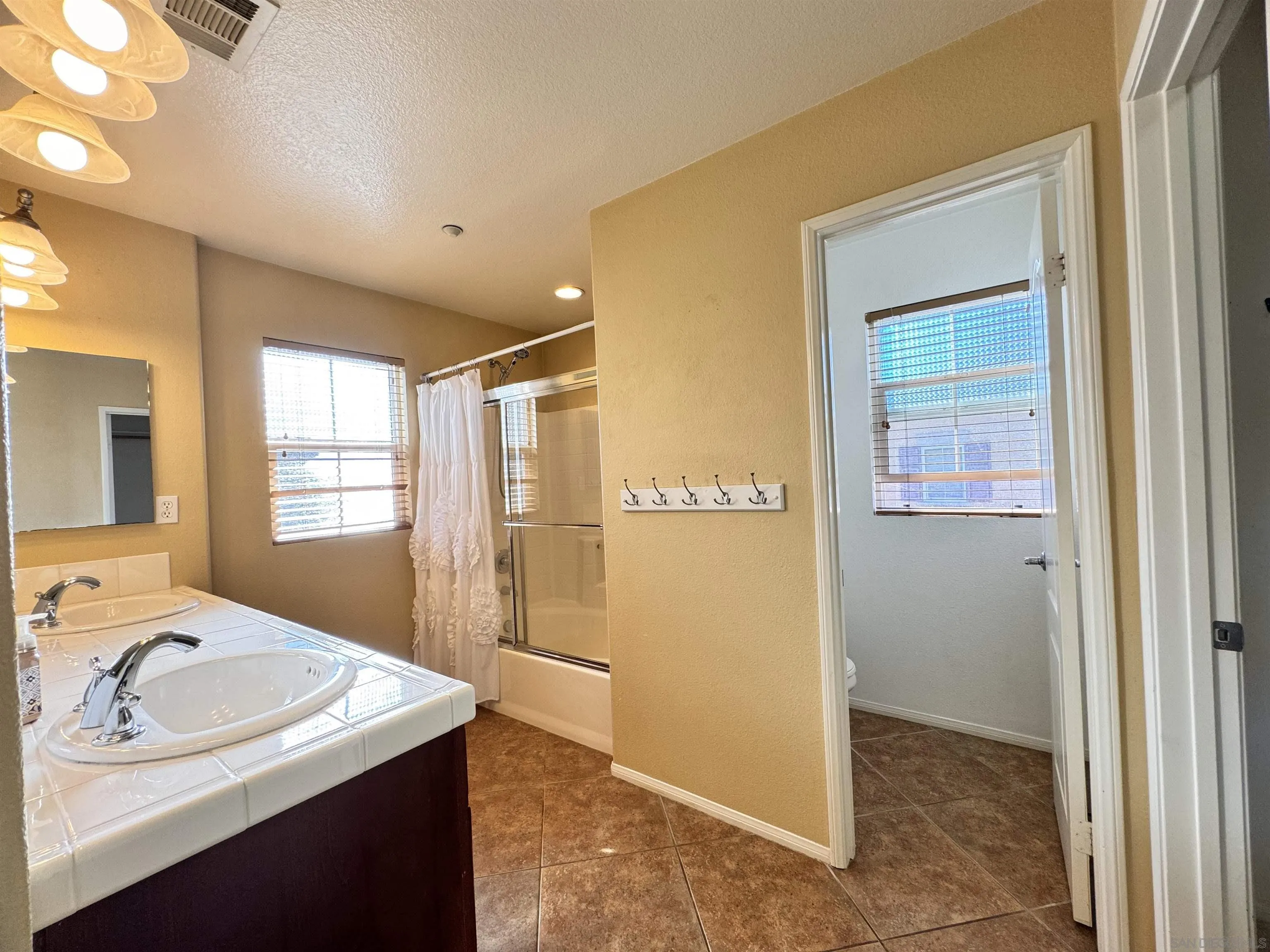 10430 Shelborne Street, Unit 37 San Diego, CA 92127 - Photo 20 of 27 a en suite bathroom with a granite countertop sink and a bathtub
