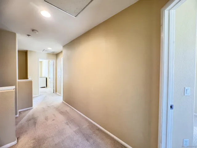 wooden floor in an empty room and a ceiling fan