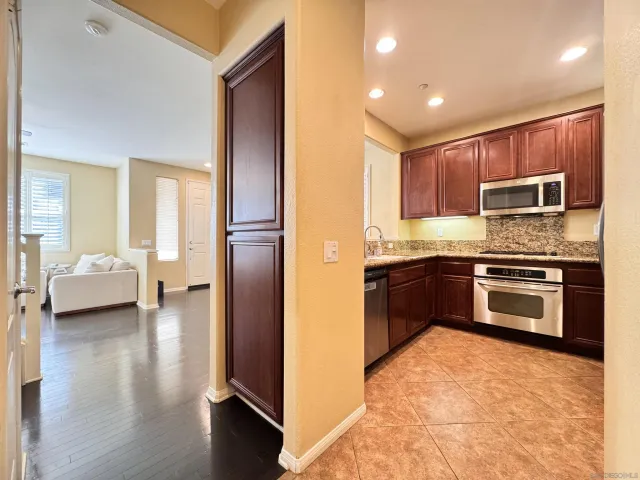 a kitchen with a refrigerator sink and cabinets