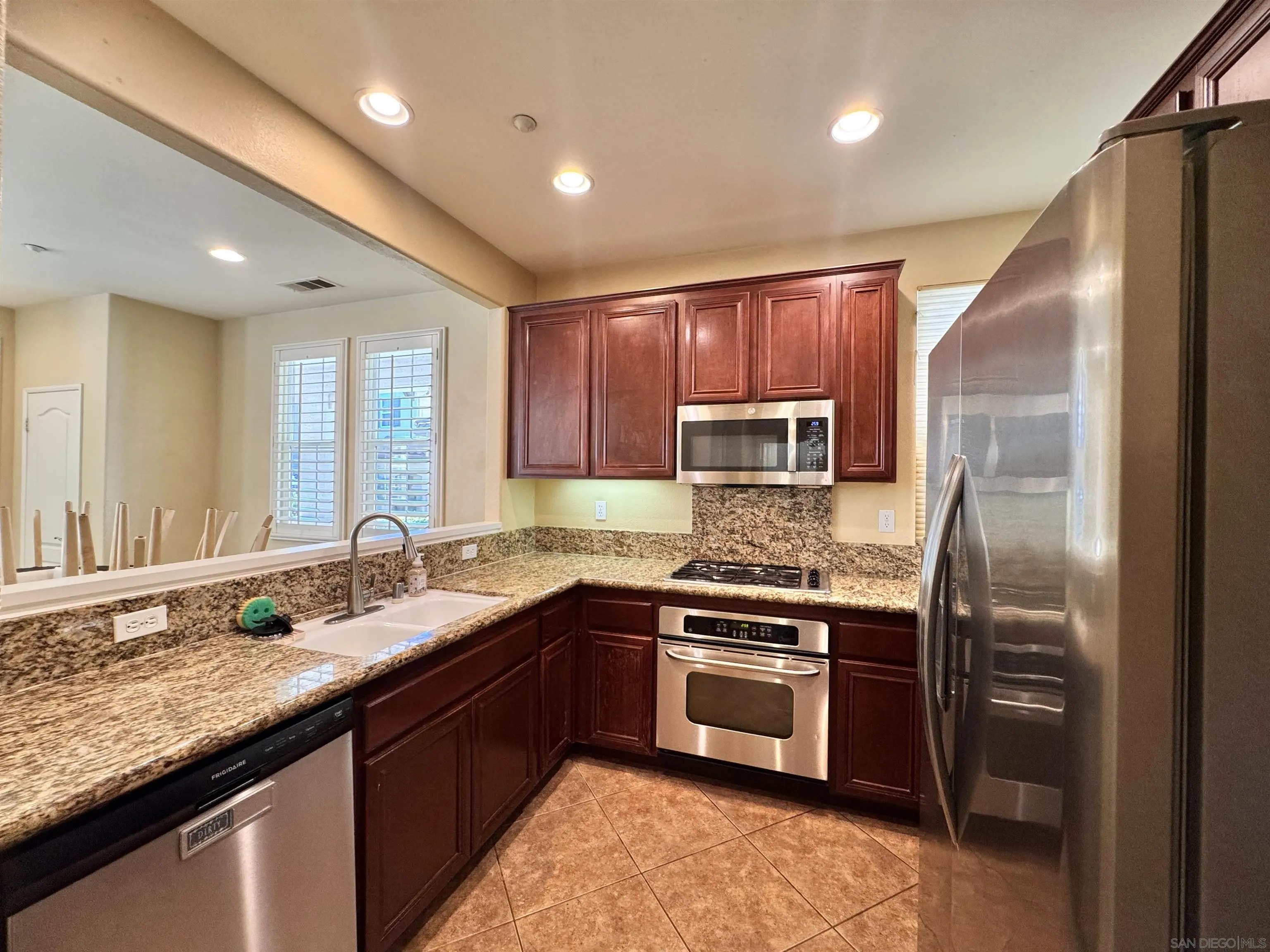 10430 Shelborne Street, Unit 37 San Diego, CA 92127 - Photo 7 of 27 a kitchen with stainless steel appliances granite countertop a sink stove and refrigerator