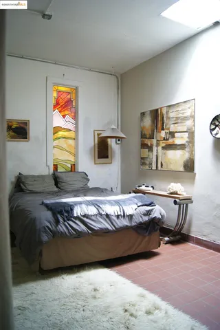 a bedroom with bed and window