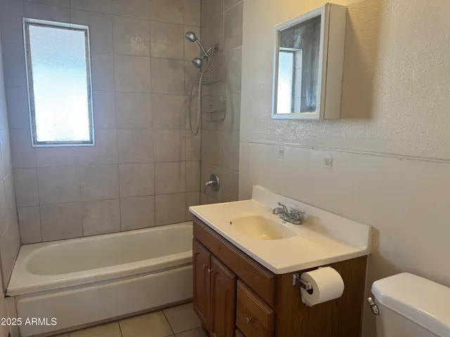 an empty room with a chandelier fan