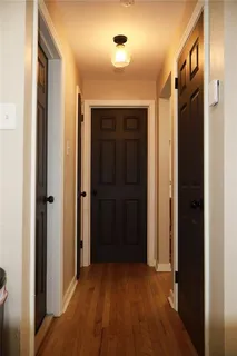 a view of hallway with wooden floor