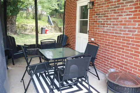 a view of a chairs and table in the balcony