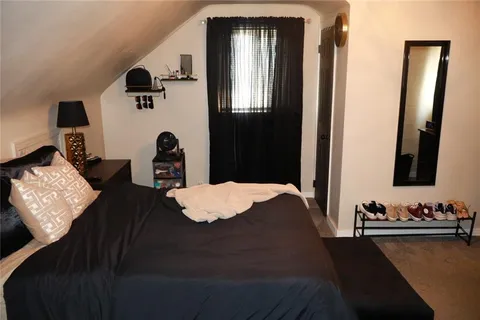 a bedroom with bed and window