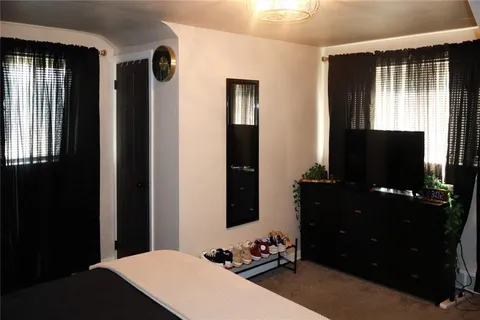 a room with furniture and flat screen tv