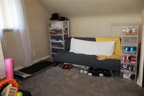 a living room with a couch and a bookshelf