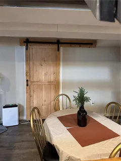 a dining room with furniture and wooden floor