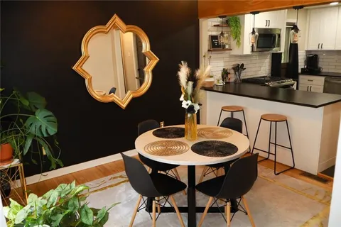 a dining room with furniture and wooden floor