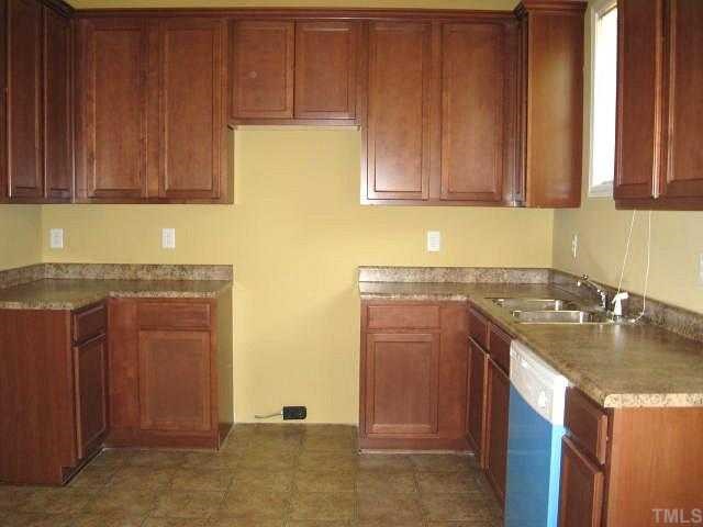 2529 Friendly Trail Raleigh, NC 27610 - Photo 3 of 12 a kitchen with stainless steel appliances granite countertop a sink stove and cabinets