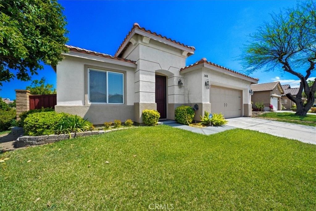 146 Ropango Way Hemet, CA 92545 - Photo 1 of 1 a front view of a house with garden and garage