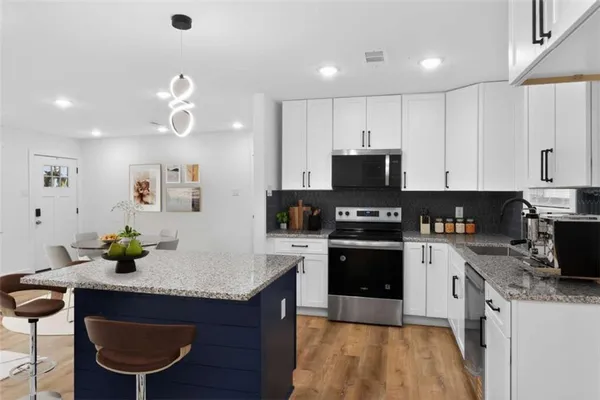 a kitchen with a sink cabinets and stainless steel appliances