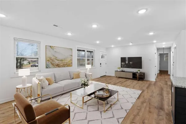 a living room with furniture and a flat screen tv