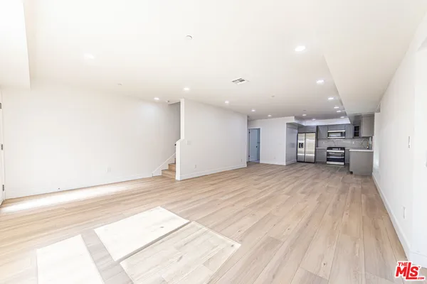 a view of empty room with a fireplace