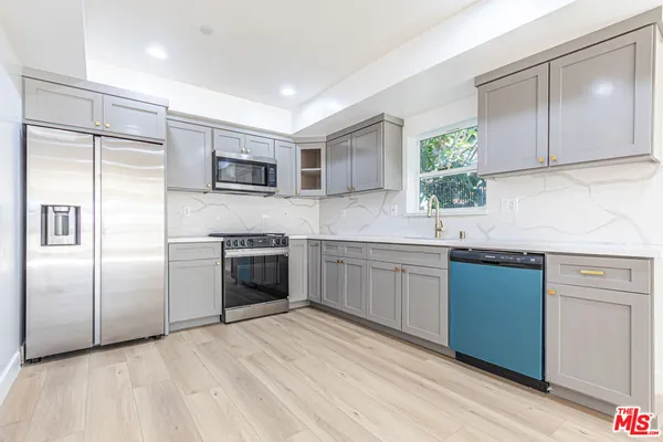 a kitchen with a refrigerator sink and microwave