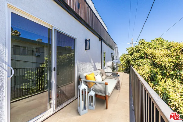 a white building with glass windows and table